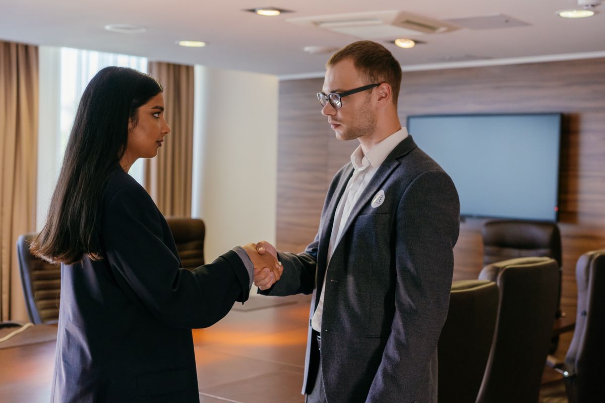 Two professionals shaking hands after a successful interview